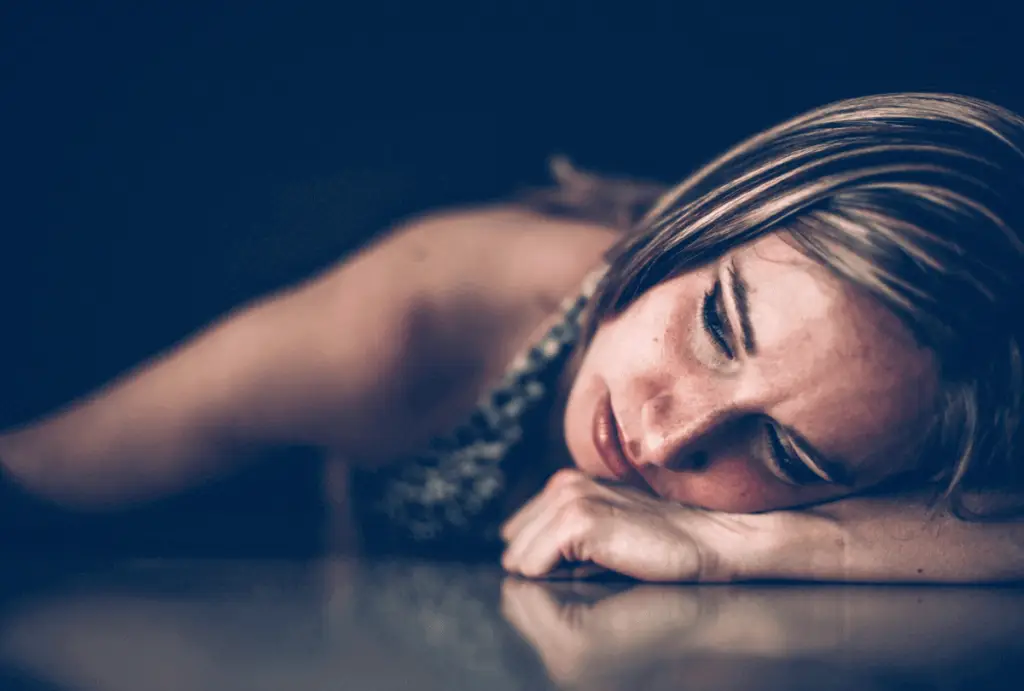 woman looking out window struggling with trauma and addiction for Janina Fisher blog 23