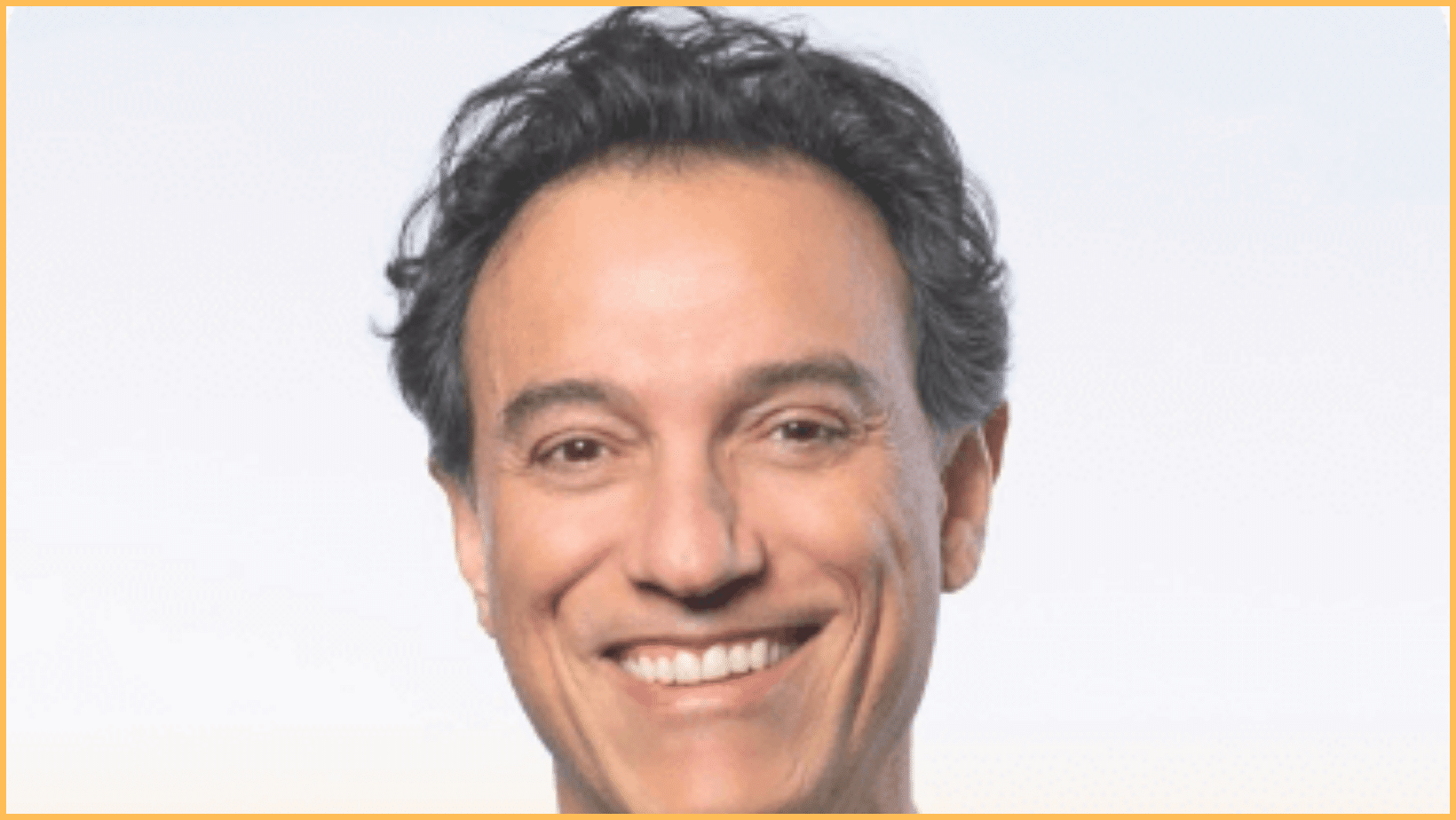 Smiling person with short dark hair.