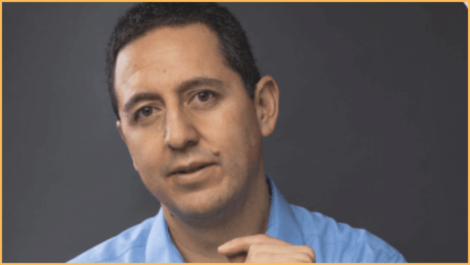 Man in blue shirt, serious expression