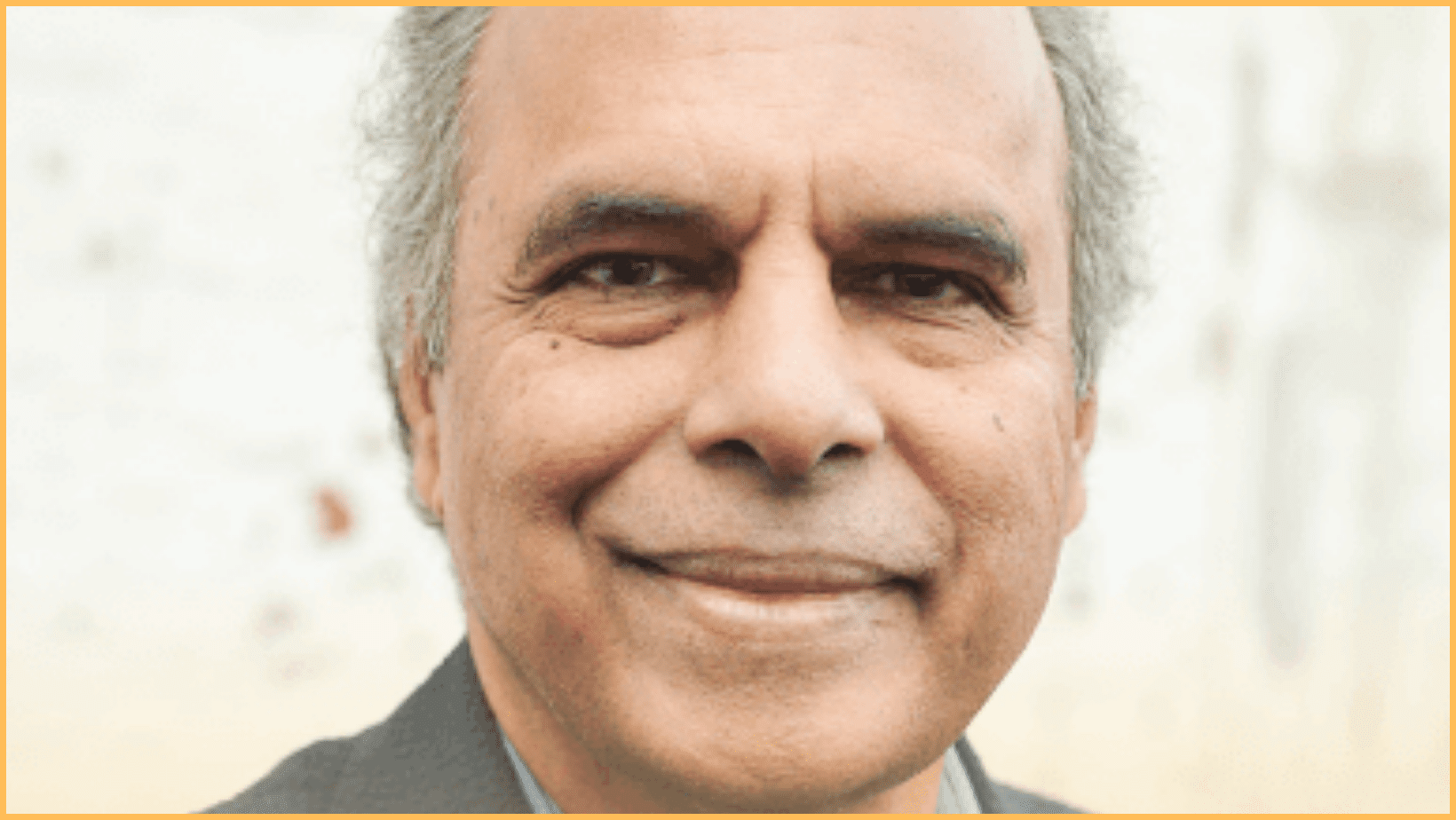 Smiling man with gray hair, close-up portrait.