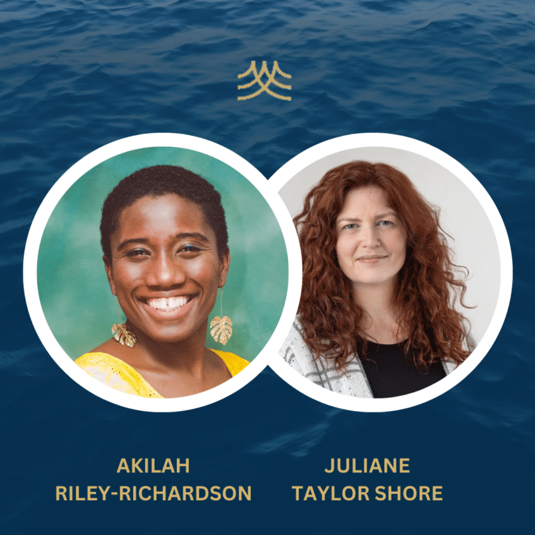 Two women smiling against blue ocean background.