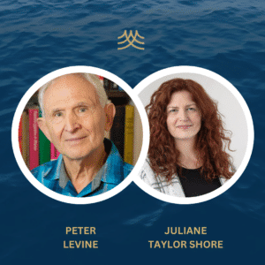 Two people smiling with ocean background.