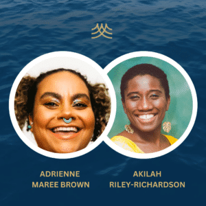 Two women smiling against ocean background