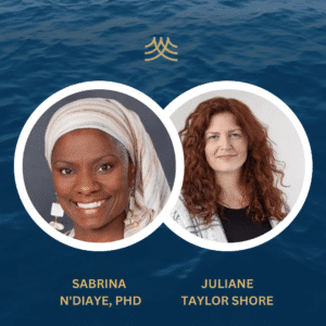 Two women smiling with ocean background.