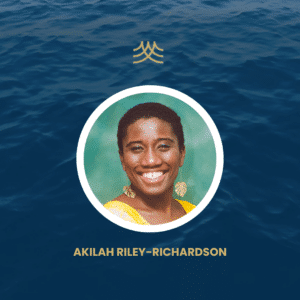 Smiling person with leaf earrings on blue background