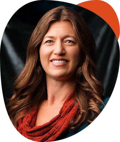 Smiling woman with long brown hair and scarf.