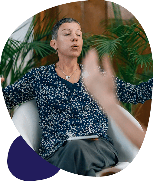 Person meditating with closed eyes in conversation.