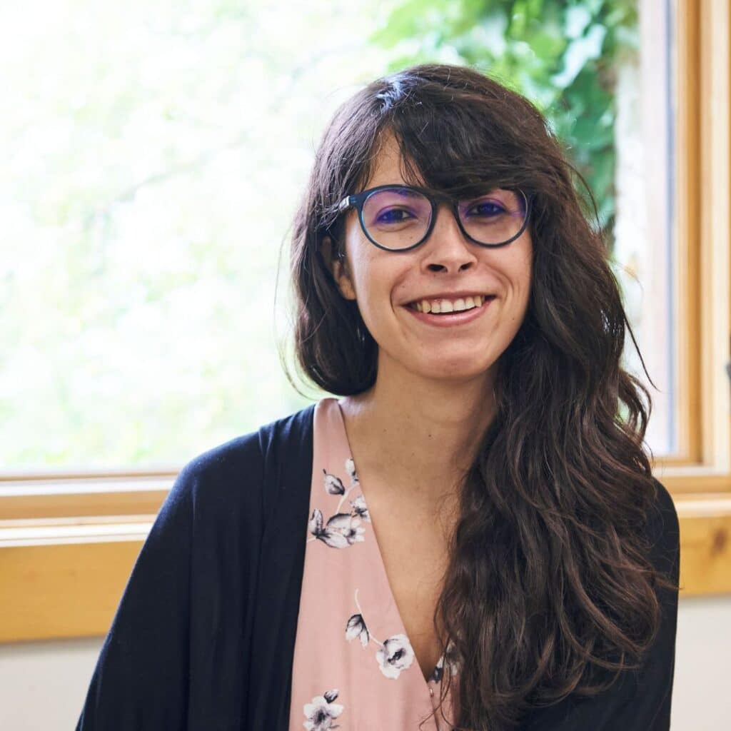 Smiling woman with glasses in floral blouse