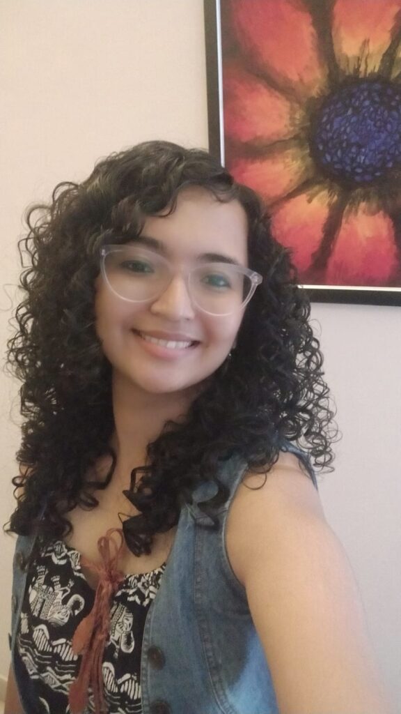 Woman smiling with colorful flower painting background.