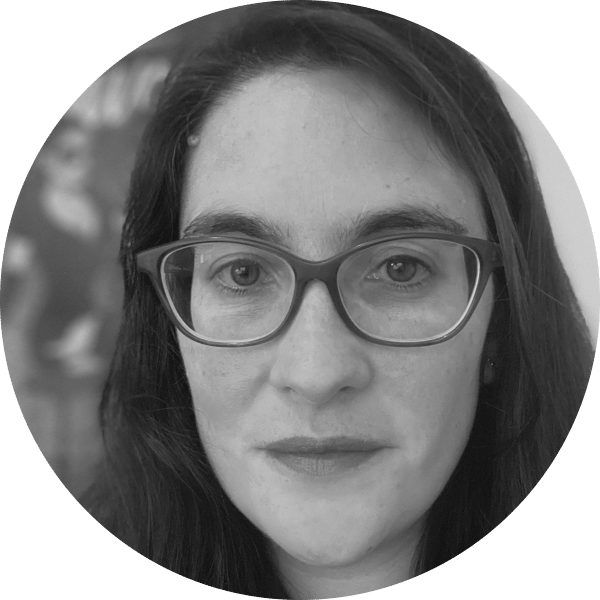 Person wearing glasses in grayscale portrait.