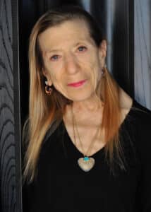 Person with long hair wearing jewelry.