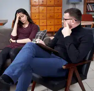 Therapist and client in counseling session, discussing issues.