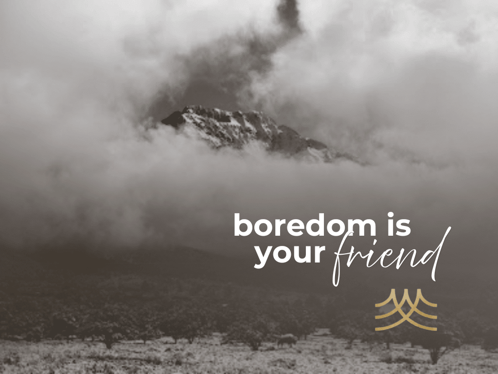 Misty mountain with inspirational text, 'boredom is your friend' - Brian Spielmann