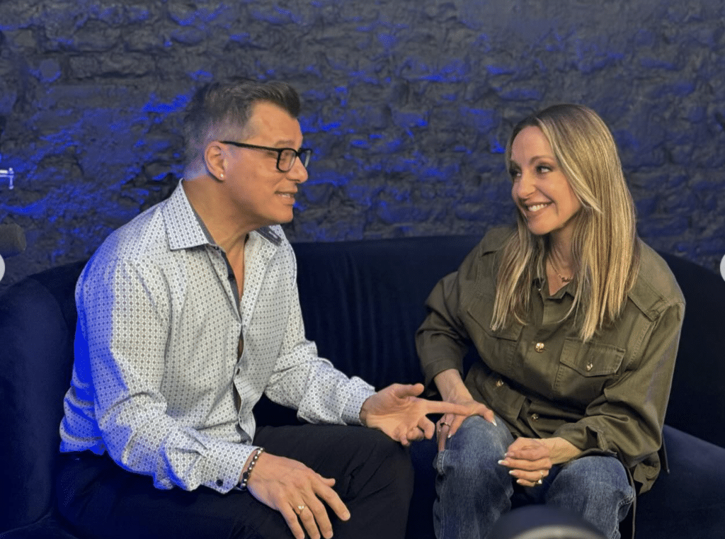 Two people chatting on a couch in studio