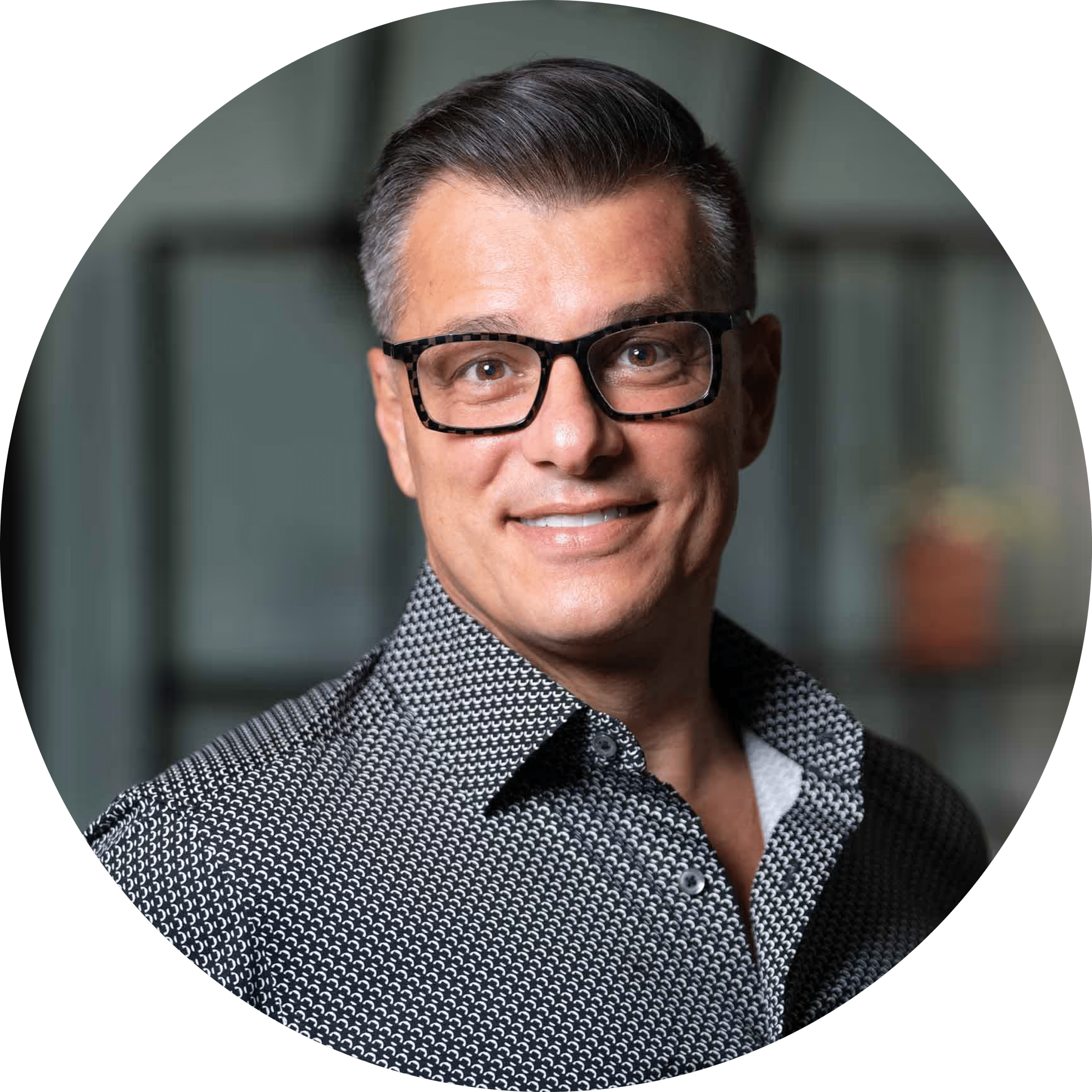 Smiling man with glasses in professional headshot