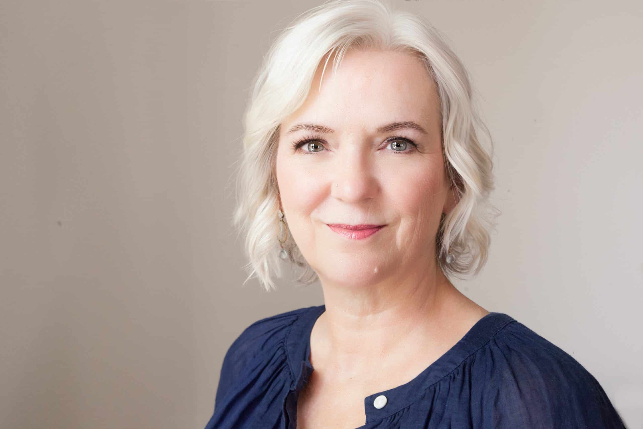 Professional headshot of smiling middle-aged woman